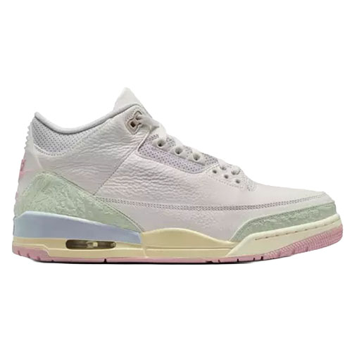 A light-colored sneaker with pastel accents, featuring a textured upper and visible air unit in the sole, resembling a classic basketball shoe design.