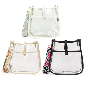 Three clear tote bags with colored trims and patterned inserts, featuring top handles and front clasps.