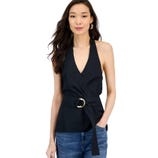 A woman wearing a black halter top with a V-neckline and a belt featuring a gold ring buckle, paired with blue jeans.
