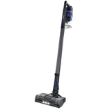 A cordless stick vacuum cleaner with an upright design, LED headlights, and a transparent dustbin for easy visibility of contents.