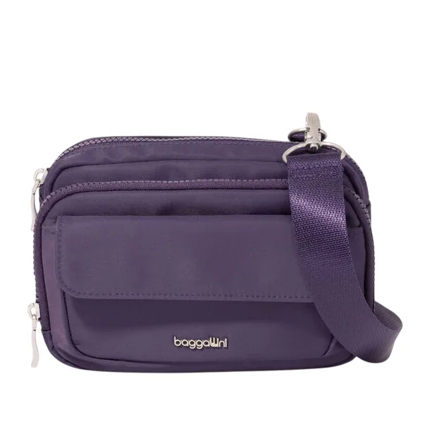 Purple crossbody bag with an adjustable strap, featuring multiple zippered compartments and a flap pocket, branded with \“baggallini.\“