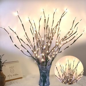 LED light branches in a vase create an illuminated decorative display, ideal for festive or ambient home decor. A small calendar nearby displays a festive greeting and a smiley face.