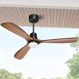 Ceiling fan with three wooden blades and a central light, mounted to a black motor housing suitable for indoor or outdoor use.