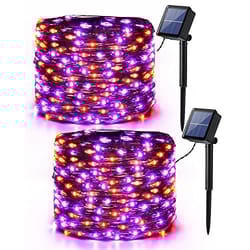 Solar-powered string lights with purple and orange LEDs, featuring two solar panels with stakes for outdoor decoration.