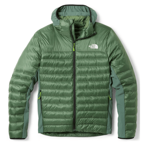 Green puffer jacket with a front zipper, zippered pockets, and a logo on the chest, featuring a quilted design for insulation.