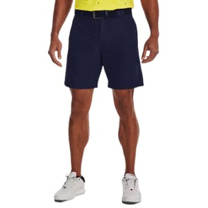 UA Golf Iso-Chill Airvent Shorts are navy blue, knee-length shorts designed to keep you cool with Iso-Chill fabric. They feature a flat front, belt loops, and are paired with white athletic shoes.
