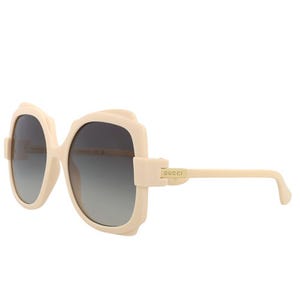 Gucci GG1431S sunglasses feature oversized square beige frames with gradient lenses and subtle branding on the temple.