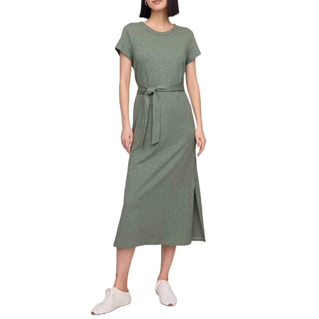 Green belted T-shirt midi dress with short sleeves and a side slit, paired with white sneakers.