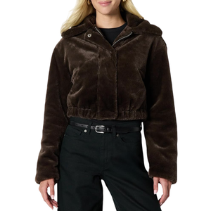 A woman is wearing a cropped dark brown faux fur jacket with a hood and button details, paired with black pants and a black belt.