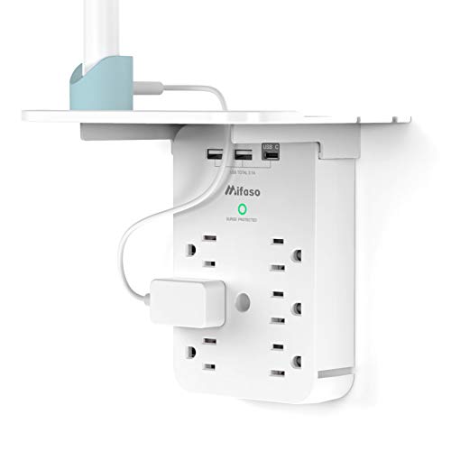 Wall-mounted power strip with multiple outlets and USB ports, featuring a small integrated shelf for organizing devices and cables.