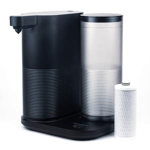 A sleek black and silver countertop water filtration system with a detachable cylindrical filter.