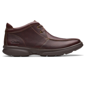 Brown leather mid-top shoe with a moc-toe design, featuring two eyelets for lacing and a cushioned sole.