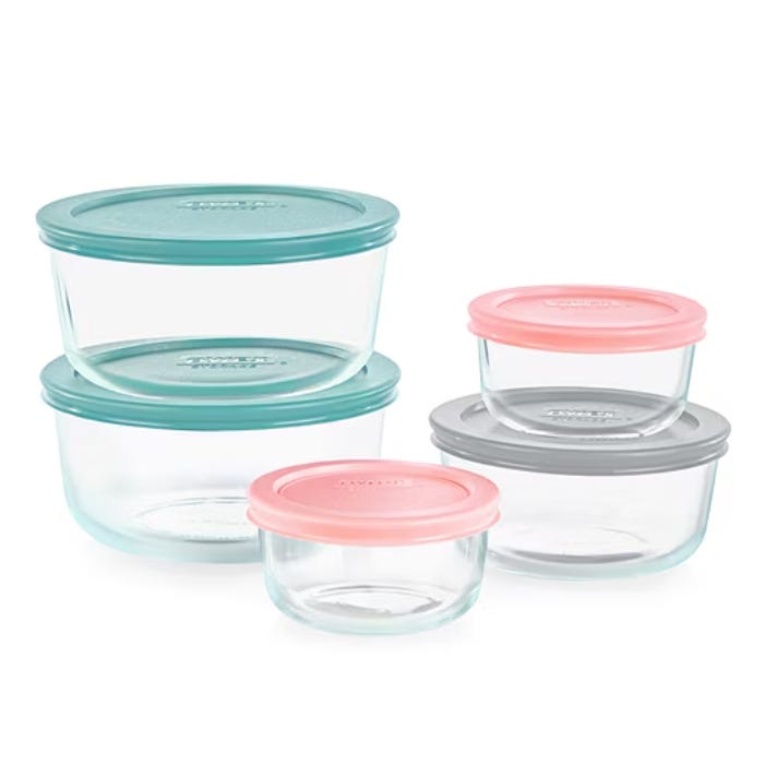 A set of round glass storage containers with lids in various colors, including teal, pink, and gray. The containers are stackable and come in different sizes, ideal for organizing or storing food.
