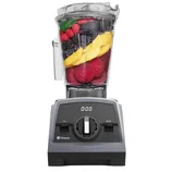 Vitamix blender filled with colorful fruits and vegetables, featuring a digital timer and adjustable speed dial on the front panel.