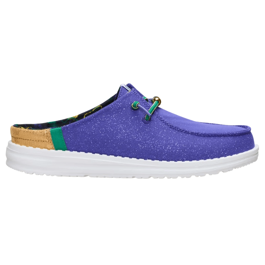 A purple slip-on shoe with a white sole, speckled design, and green accents, featuring a backless style and decorative laces.