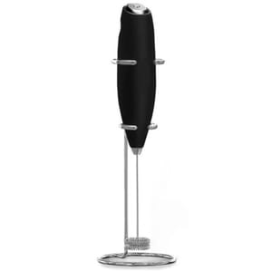 A handheld electric milk frother with a black handle, equipped with a stainless steel whisk and a stand.