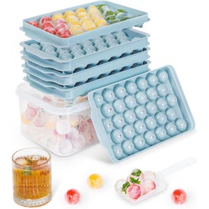 The image shows a 99-piece ice cube-making kit with light blue trays designed for creating round ice cubes. The set includes a stackable system and a clear storage container, featuring colorful infused ice balls.