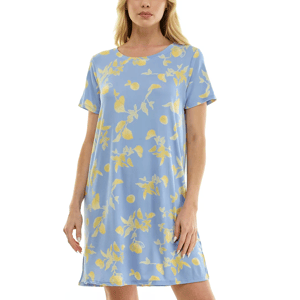 A woman is wearing a short-sleeved, knee-length blue dress with a yellow floral and fruit pattern.