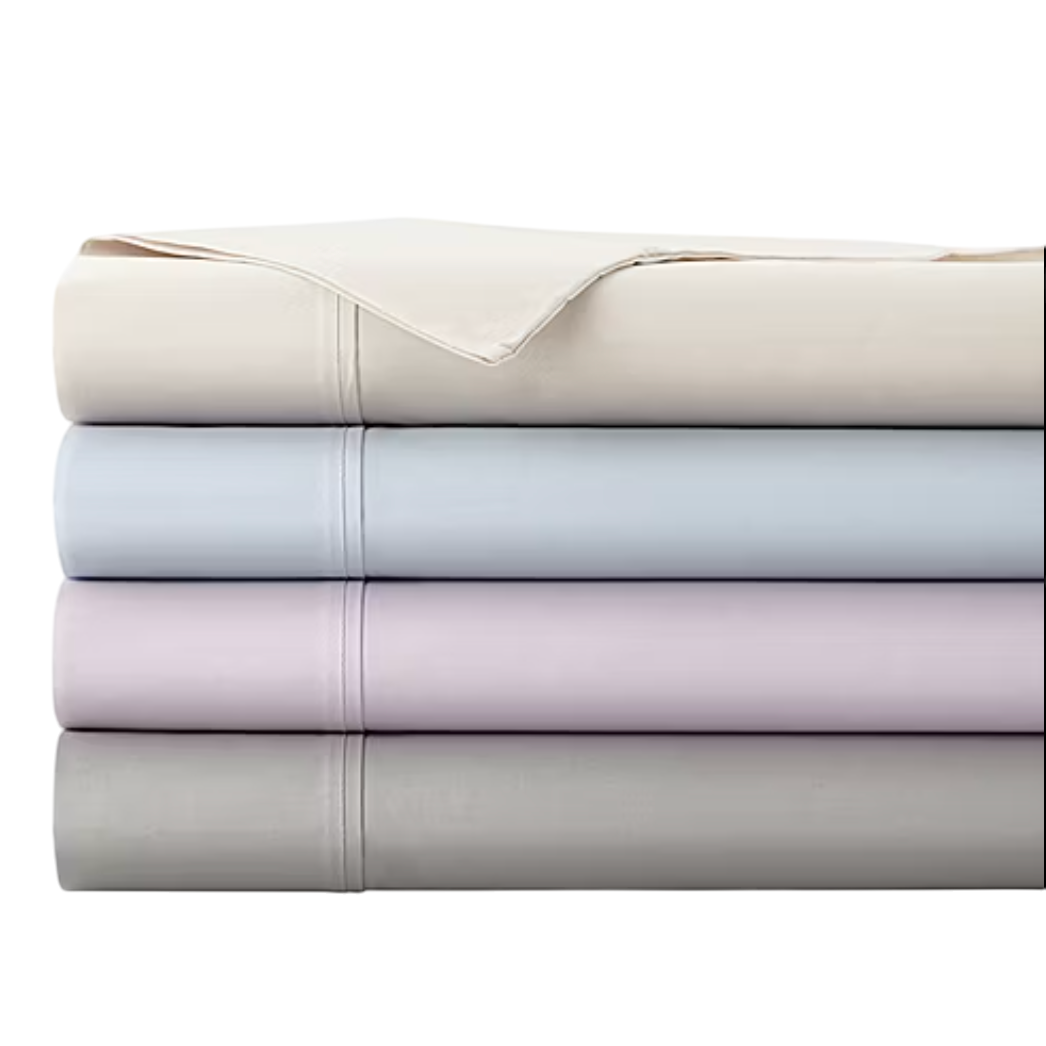 A stack of neatly folded bed sheets in four pastel colors: cream, light blue, lavender, and gray, with visible stitching details.