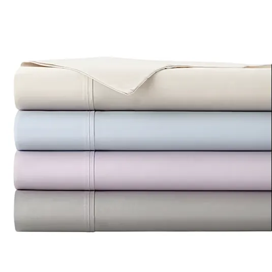 A stack of neatly folded bed sheets in four pastel colors: cream, light blue, lavender, and gray, with visible stitching details.