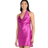 A woman is wearing a bright pink, satin, halter-neck mini dress with a cowl neckline and decorative strap details.