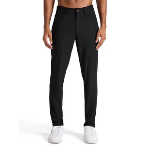 A pair of slim-fit black pants worn by a person, paired with white sneakers.