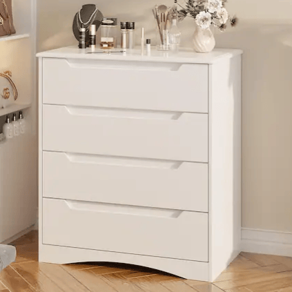 A white dresser with four drawers is adorned with cosmetics, a mirror, jewelry, and a floral vase on top.