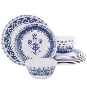 A blue and white dinnerware set featuring plates and bowls with floral and geometric patterns.
