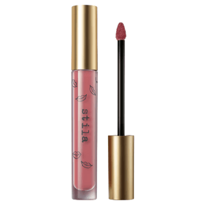 A tube of Stila liquid lipstick with a golden cap and applicator wand, featuring a pink shade with lip prints on the packaging.