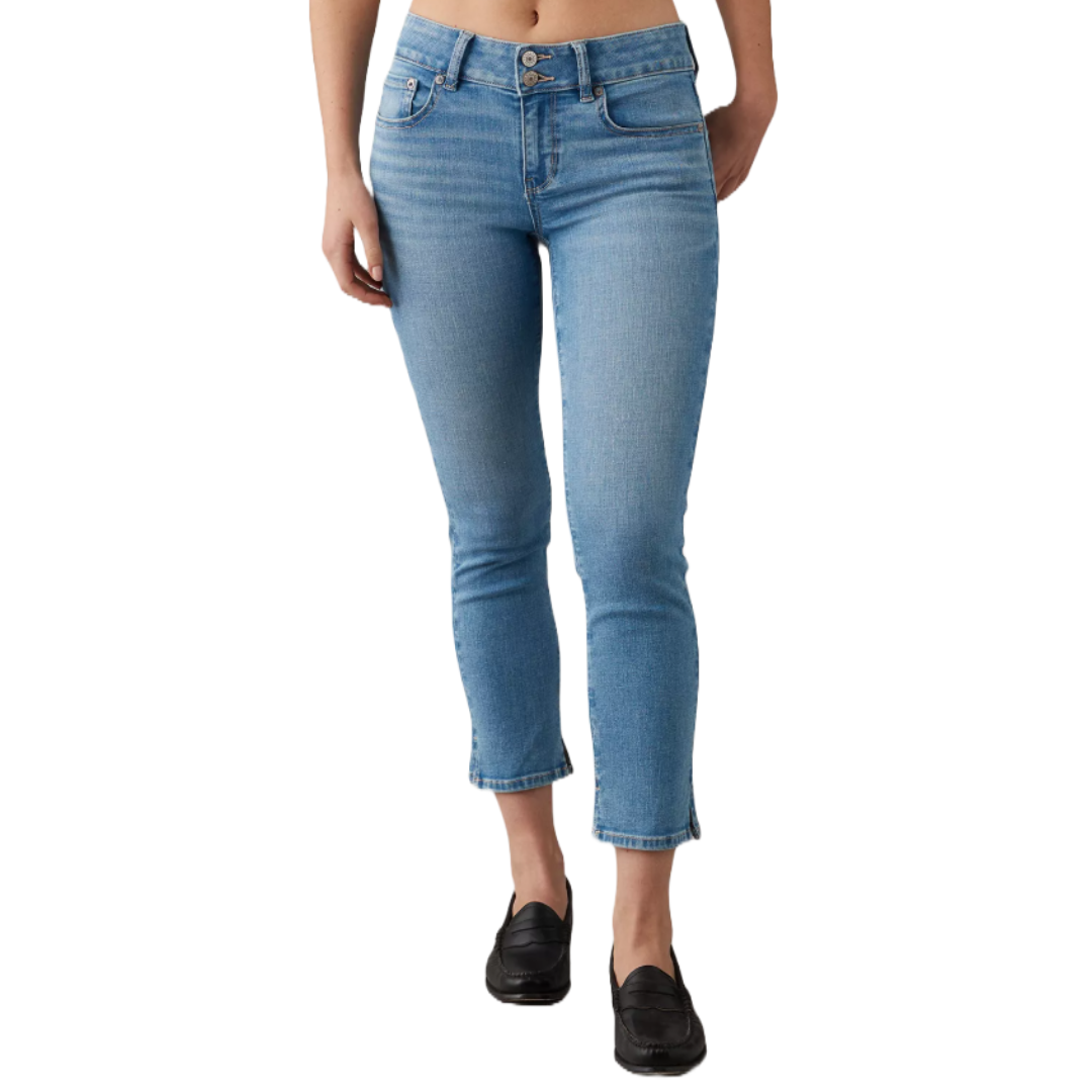 A person is wearing light blue cropped skinny jeans with a high waist, paired with black loafers. The jeans have a classic five-pocket design and a front zipper fly.