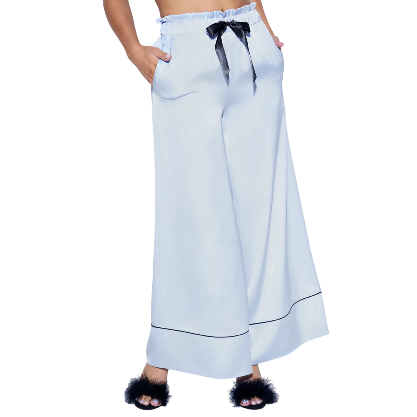 Light blue wide-leg pants with an elasticated ruffled waistband, black ribbon tie, and black piping near the cuffs, paired with black fuzzy open-toe slippers.