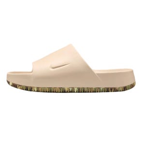 A beige slide sandal with a camo-patterned sole and a subtle swoosh logo on the side.
