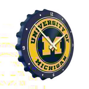 This is a bottle cap-shaped wall clock with the University of Michigan logo.