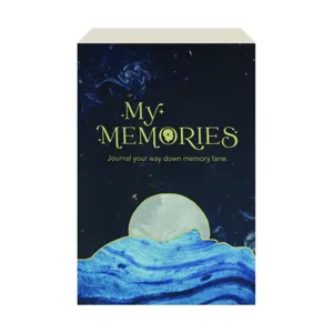 A journal titled \“My Memories\“ features a celestial-themed cover with a moonrise over blue waves and the tagline \“Journal your way down memory lane.\“