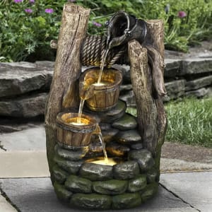 A rustic outdoor water fountain with a design resembling a wooden well and buckets, complete with a simulated water flow.