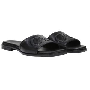 Black leather slide sandals with open toes and a slight heel, featuring an embossed decorative design on the strap.
