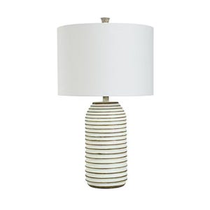 A table lamp with a white, drum-shaped shade and a cylindrical base with horizontal stripes.