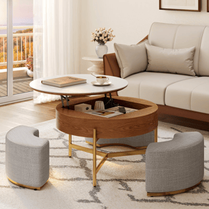 Round lift-top coffee table with a wooden base and white tabletop, featuring interior storage. Comes with two semi-circular gray upholstered stools that fit underneath, set on a patterned rug in a modern living room.