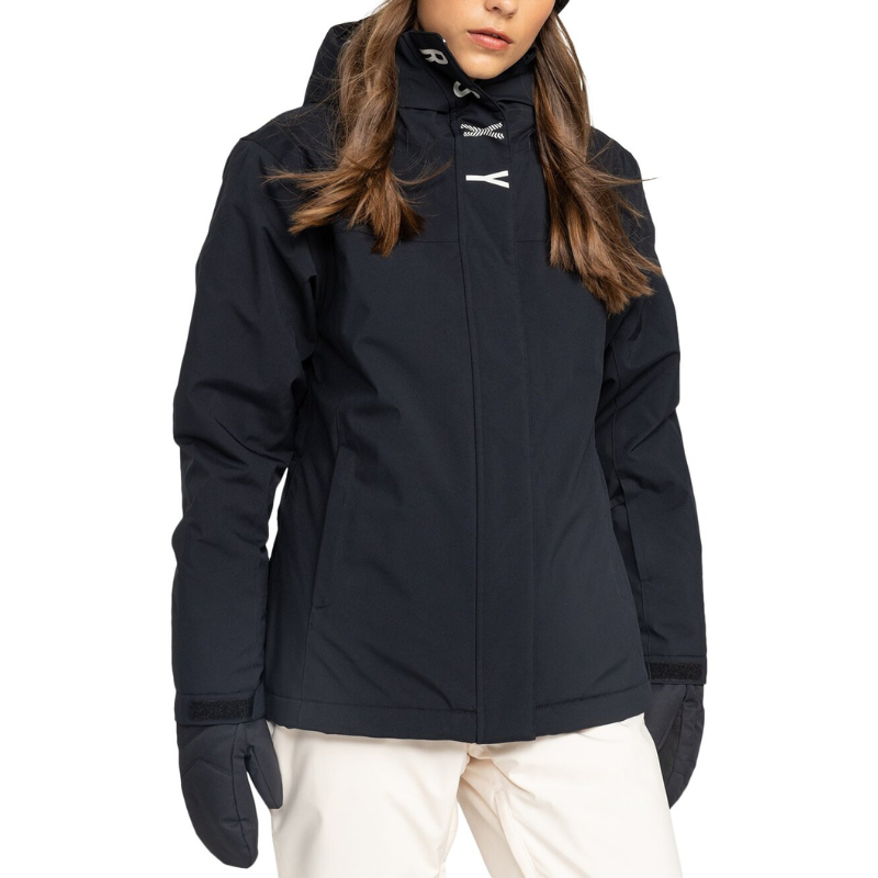 The Roxy Galaxy Snow Jacket is a black winter coat featuring a high collar, hood, and Velcro-adjustable cuffs, with concealed front zipper. It's designed for cold weather activities, paired here with white pants and matching gloves.