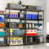 Garage shelves with various tools, storage bins, motor oil, epoxy cans, tires, and bottled water.