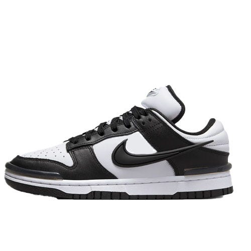 A black and white low-top sneaker with a prominent black swoosh logo, featuring a two-tone upper and rubber sole.