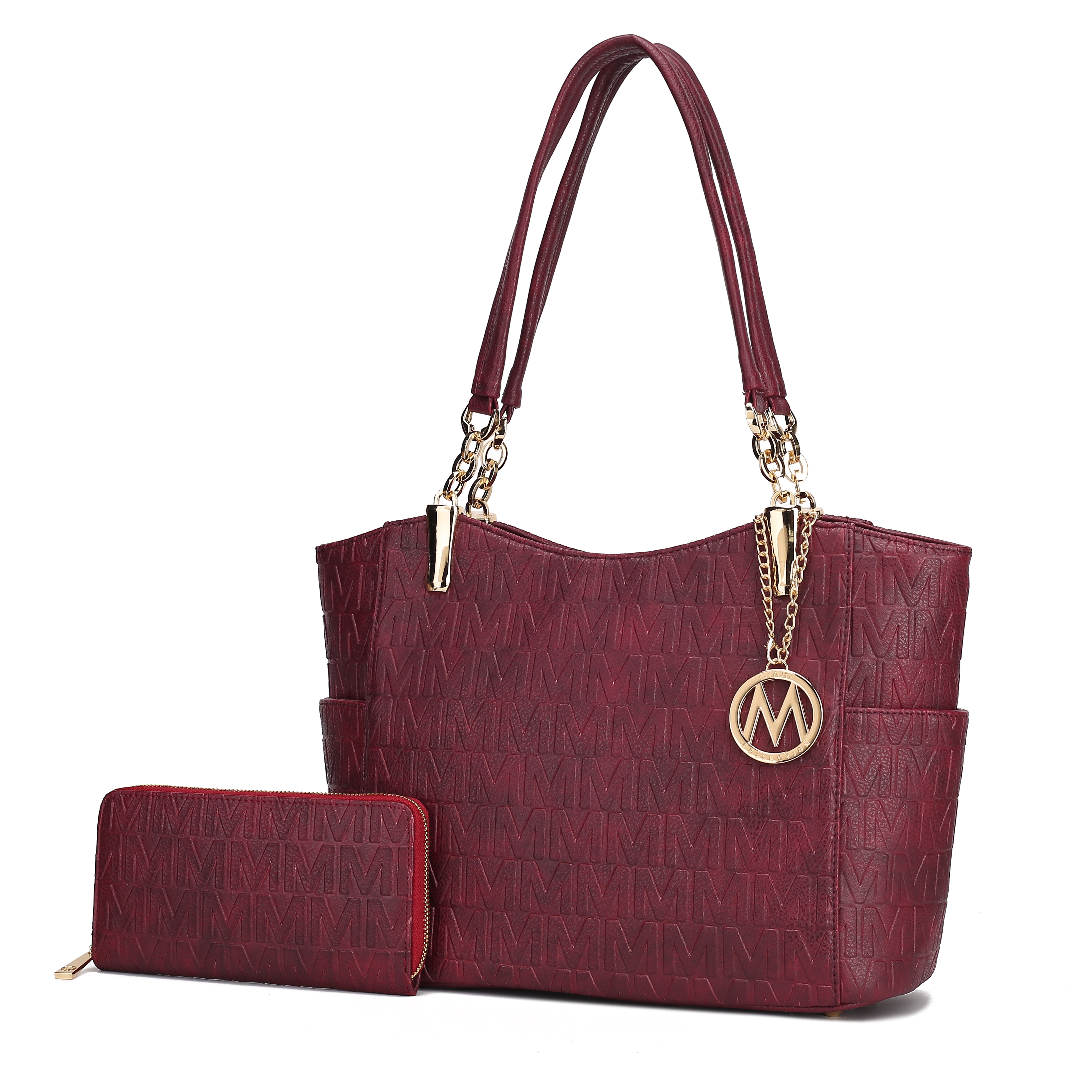 A maroon handbag with a gold chain detail and matching wallet, both featuring a repeating \“M\“ pattern and a gold circular emblem charm.