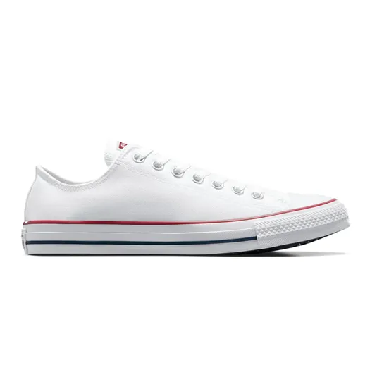 A classic low-top white canvas sneaker with white laces, featuring red and blue stripes on the rubber sole.
