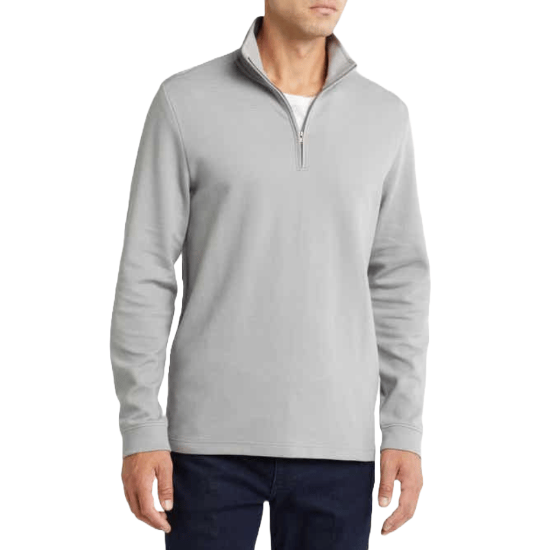 A light grey half-zip sweatshirt with long sleeves and a straight fit, worn over a white undershirt.