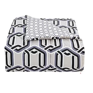 A modern geometric-patterned comforter set in shades of gray, black, and white, featuring a reversible design with different patterns on each side.