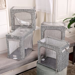 4pk Periea Collapsible Storage Boxes are gray with transparent sides and tops, featuring zippers and handles for convenience. They are structured yet foldable, ideal for organizing and storing items neatly.