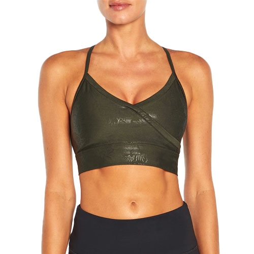 A dark green, strappy sports bra with a wrap-style front and subtle textured pattern, paired with black athletic bottoms.