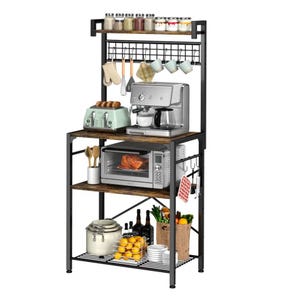 A multi-tier kitchen rack with a coffee machine, toaster, and microwave. It includes shelves with jars, cups, a wine rack, and hooks for utensils. The bottom shelf holds a jar, lemons, dishes, and a basket with bottles and vegetables.