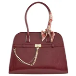 A burgundy handbag with dual handles, featuring a gold chain and lock embellishment. A plaid ribbon is tied on one handle for decoration.