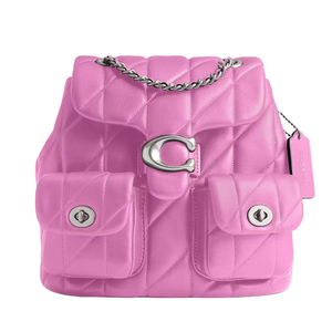 Pink quilted backpack with a metal chain strap and two front pockets, featuring a prominent metallic \“C\“ clasp and a logo tag.